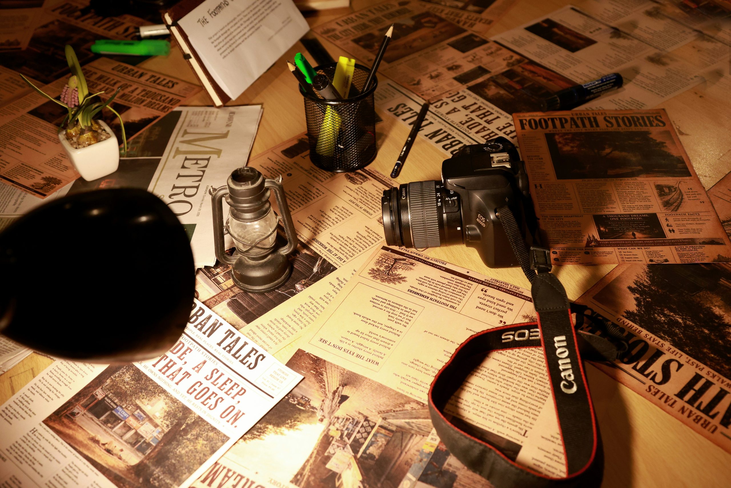 Newspaper, camera and journalism workspace representing Free Ink Post newsroom
